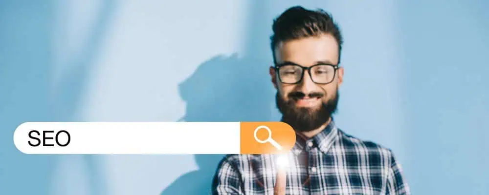 Man pointing at a screen that reads SEO