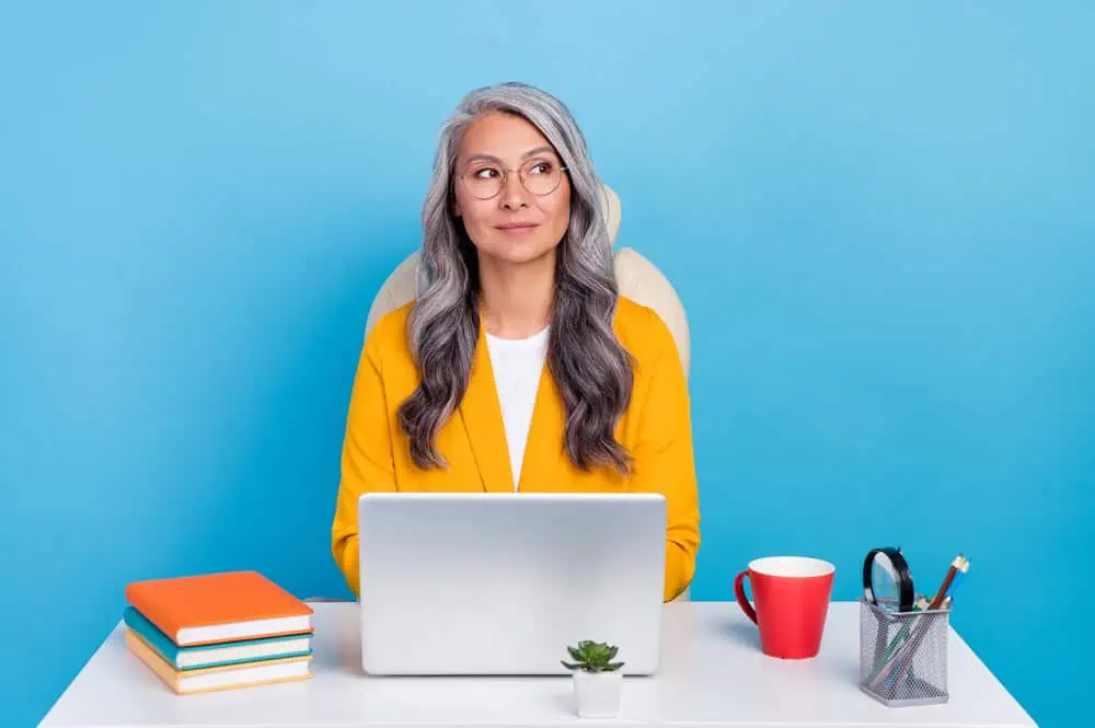 Woman coaching a client on her laptop